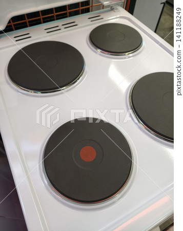 White electric stove designed with four burners, top view 141188249