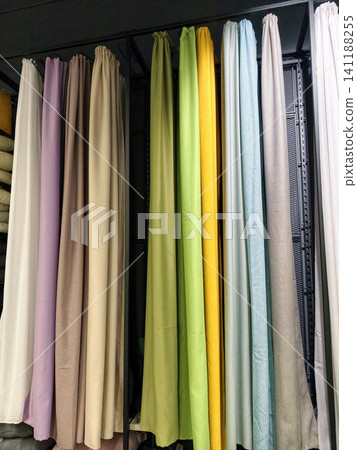 Multicolored curtains in a variety of shades arranged neatly inside a shop Multicolored curtains in a variety of shades arranged neatly inside a shop 141188255