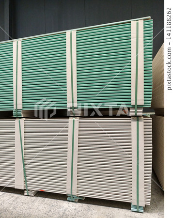 Drywall panels stored efficiently on pallets in a construction supplies warehouse Drywall panels stored efficiently on pallets in a construction supplies warehouse 141188262