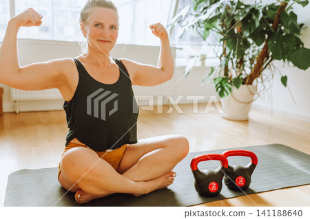 middle-aged woman doing Pilates at home middle-aged woman doing Pilates at home 141188640
