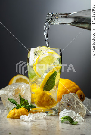 Carbonated refreshing drink with fresh lemon, ice and mint. 141188953