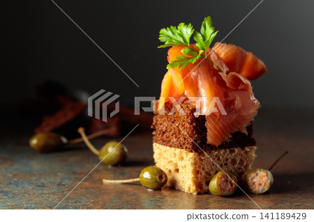 Open sandwich with smoked salmon and capers. Open sandwich with smoked salmon and capers. 141189429