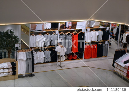 Summer sales clothing store display with dresses shirts and racks for retail banner and window display background Summer sales clothing store display with dresses shirts and racks for retail banner and window display background 141189486
