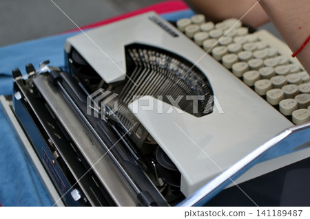 Close-up vintage mechanical typewriter keyboard and carriage for retro writing background and editorial design Close-up vintage mechanical typewriter keyboard and carriage for retro writing background and editorial design 141189487