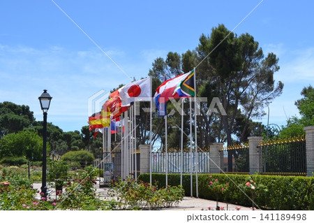 Outdoor international flags at madrid rose garden entrance for travel background and park banner design Outdoor international flags at madrid rose garden entrance for travel background and park banner design 141189498
