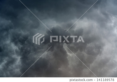 panoramic view of a cloudscape of a sky with a gloomy dark storm clouds panoramic view of a cloudscape of a sky with a gloomy dark storm clouds 141189578