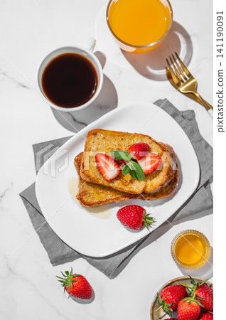 Brioche toasts with strawberry and honey on a plate on a marble background Brioche toasts with strawberry and honey on a plate on a marble background 141190091