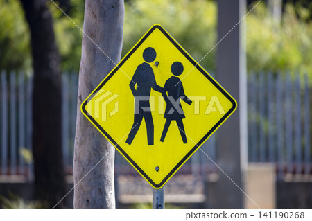 A pedestrian crossing sign located near a road in Western Sydney A pedestrian crossing sign located near a road in Western Sydney 141190268