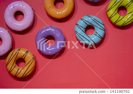Colorful Artificial Donuts Background Pattern. Colorful Artificial Donuts Background Pattern. 141190702