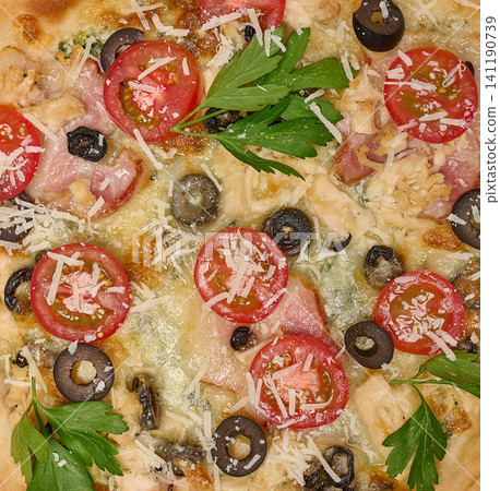 Close-up of delicious pizza with tomato, olive, bacon, chicken, grated cheese and parsley Close-up of delicious pizza with tomato, olive, bacon, chicken, grated cheese and parsley 141190739