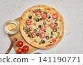 Round pizza with bacon, chicken, olives and cheese on white background 141190771