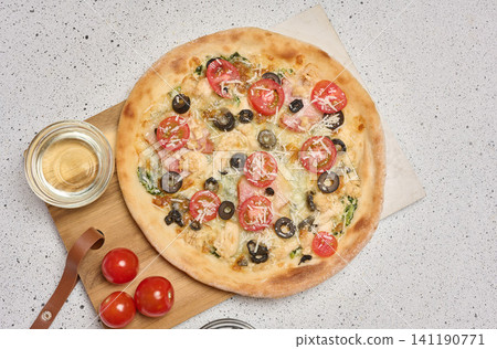 Round pizza with bacon, chicken, olives and cheese on white background Round pizza with bacon, chicken, olives and cheese on white background 141190771