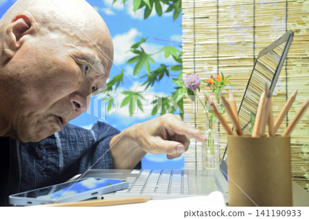 A close-up of a laptop computer and an old man's face. A close-up of a laptop computer and an old man's face. 141190933