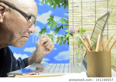 A close-up of a laptop computer and an old man's face. A close-up of a laptop computer and an old man's face. 141190937