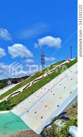 Blue sky and a bouldering wall in a summer park Blue sky and a bouldering wall in a summer park 141191122