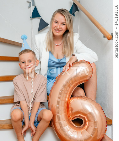 Mother and son sitting on stairs with balloons, in indoor staircase, with balloons, staircase, with textile, wooden handrail texture, from a frontal perspective, with blue, white accents. Mother and son sitting on stairs with balloons, in indoor staircase, with balloons, staircase, with textile, wooden handrail texture, from a frontal perspective, with blue, white accents. 141191316