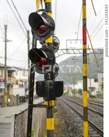 Scenery of a railroad crossing in the rain Scenery of a railroad crossing in the rain 141191693