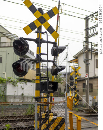 Scenery of a railroad crossing in the rain Scenery of a railroad crossing in the rain 141191694
