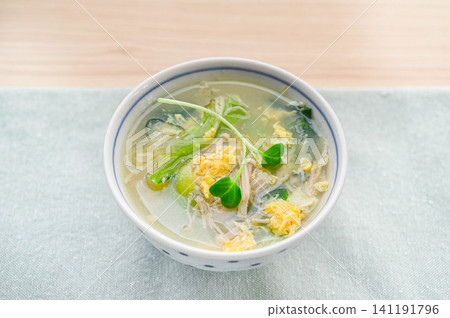 Enoki mushroom and komatsuna (Japanese mustard spinach) egg drop soup Enoki mushroom and komatsuna (Japanese mustard spinach) egg drop soup 141191796
