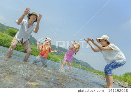 夏天,一家四口在河裡玩耍。 夏天,一家四口在河裡玩耍。 141192028