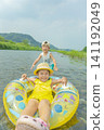 A sister and brother playing in the river in summer 141192049