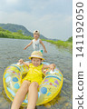 A sister and brother playing in the river in summer 141192050