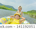 A sister and brother playing in the river in summer 141192051