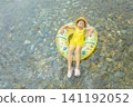 A girl playing in a river in summer 141192052