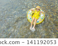 A girl playing in a river in summer 141192053