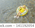A girl playing in a river in summer 141192054