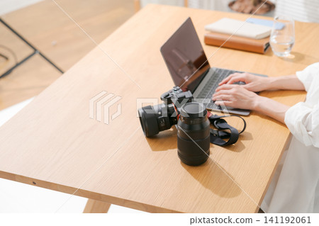 A woman's hands as she edits a photograph. A woman's hands as she edits a photograph. 141192061