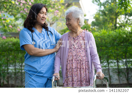 Doctor caregiver help and care Asian senior woman walking in park. Doctor caregiver help and care Asian senior woman walking in park. 141192207