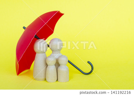 Family figures protected under a red umbrella representing security and insurance with customizable space for text. Family figures protected under a red umbrella representing security and insurance with customizable space for text. 141192216