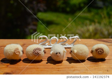New Year's greeting card material featuring wool felt sheep. New Year's greeting card material featuring wool felt sheep. 141192374