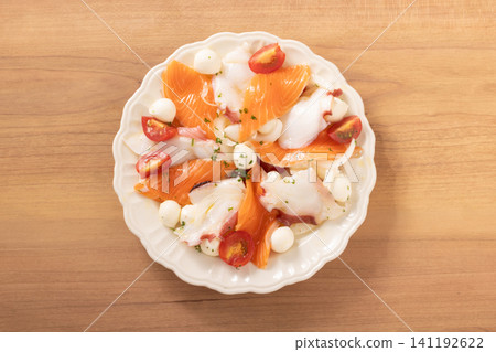 Salmon and octopus carpaccio with mozzarella cheese and cherry tomatoes Salmon and octopus carpaccio with mozzarella cheese and cherry tomatoes 141192622