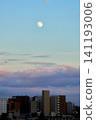 The moon rising over the city 141193006