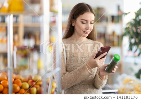 Young woman scanning qr code for seasoning herbs Young woman scanning qr code for seasoning herbs 141193176