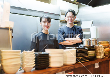 Manager and employees working at an izakaya (Japanese pub) Manager and employees working at an izakaya (Japanese pub) 141193256