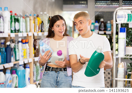 Young couple choosing laundry detergent in department store Young couple choosing laundry detergent in department store 141193625