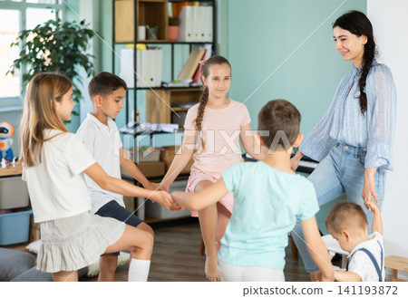Children stand together and do exercises Children stand together and do exercises 141193872