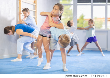 children are working on arm twists 141193905