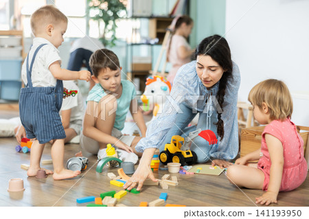 Group of children playing with various toys in kindergarten Group of children playing with various toys in kindergarten 141193950