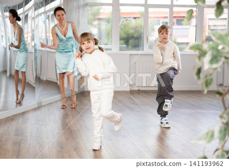 Boy and girl train to dance contemporary vigorous boogie woogie during classes. 141193962