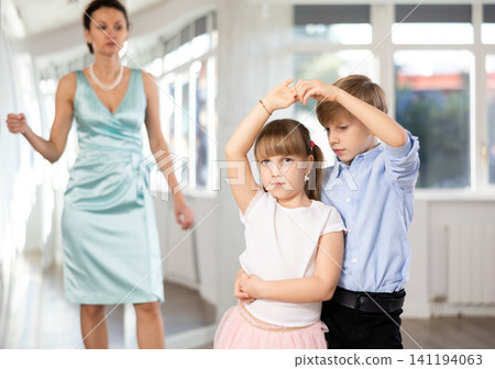 Boy and girl in pair train to dance contemporary vigorous hustle during classes. Boy and girl in pair train to dance contemporary vigorous hustle during classes. 141194063