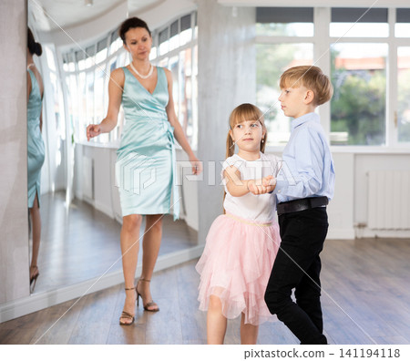 Boy and girl in pair train to dance contemporary vigorous waltz during classes. Boy and girl in pair train to dance contemporary vigorous waltz during classes. 141194118