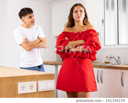 Domestic quarrel of a young family in kitchen Domestic quarrel of a young family in kitchen 141194174