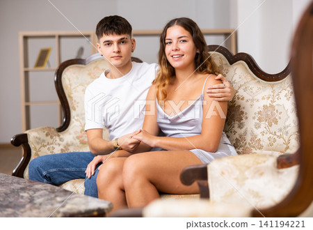 Portrait of loving family couple sitting in comfy home room Portrait of loving family couple sitting in comfy home room 141194221