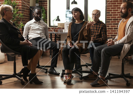 Woman talks with people in an addiction recovery meeting, leading a circle discussion about mental health, counseling and group support. Woman talks with people in an addiction recovery meeting, leading a circle discussion about mental health, counseling and group support. 141194397