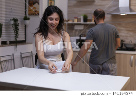 Desperate person holds a small bag of white powder, showing narcotics dependency, illegal substance abuse and the personal danger of drug addiction. Desperate person holds a small bag of white powder, showing narcotics dependency, illegal substance abuse and the personal danger of drug addiction. 141194574