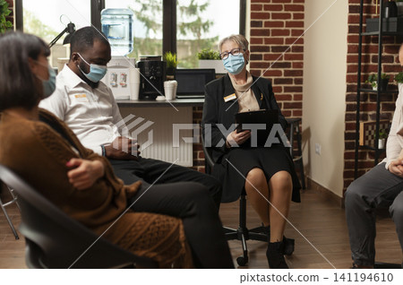 People attend a group therapy session with a psychologist, discussing alcohol addiction, anger issues and recovery support in a counseling circle. 141194610